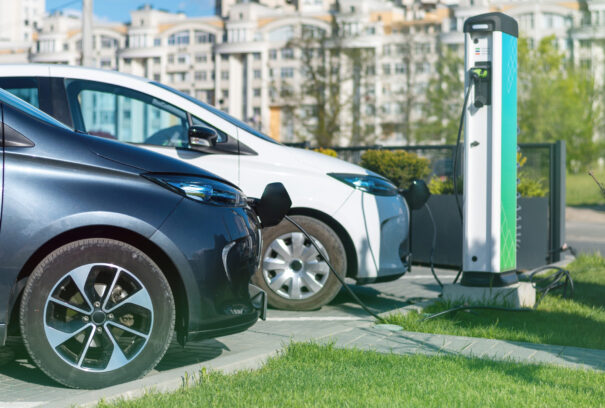 Two charging electric cars at charge station in the city